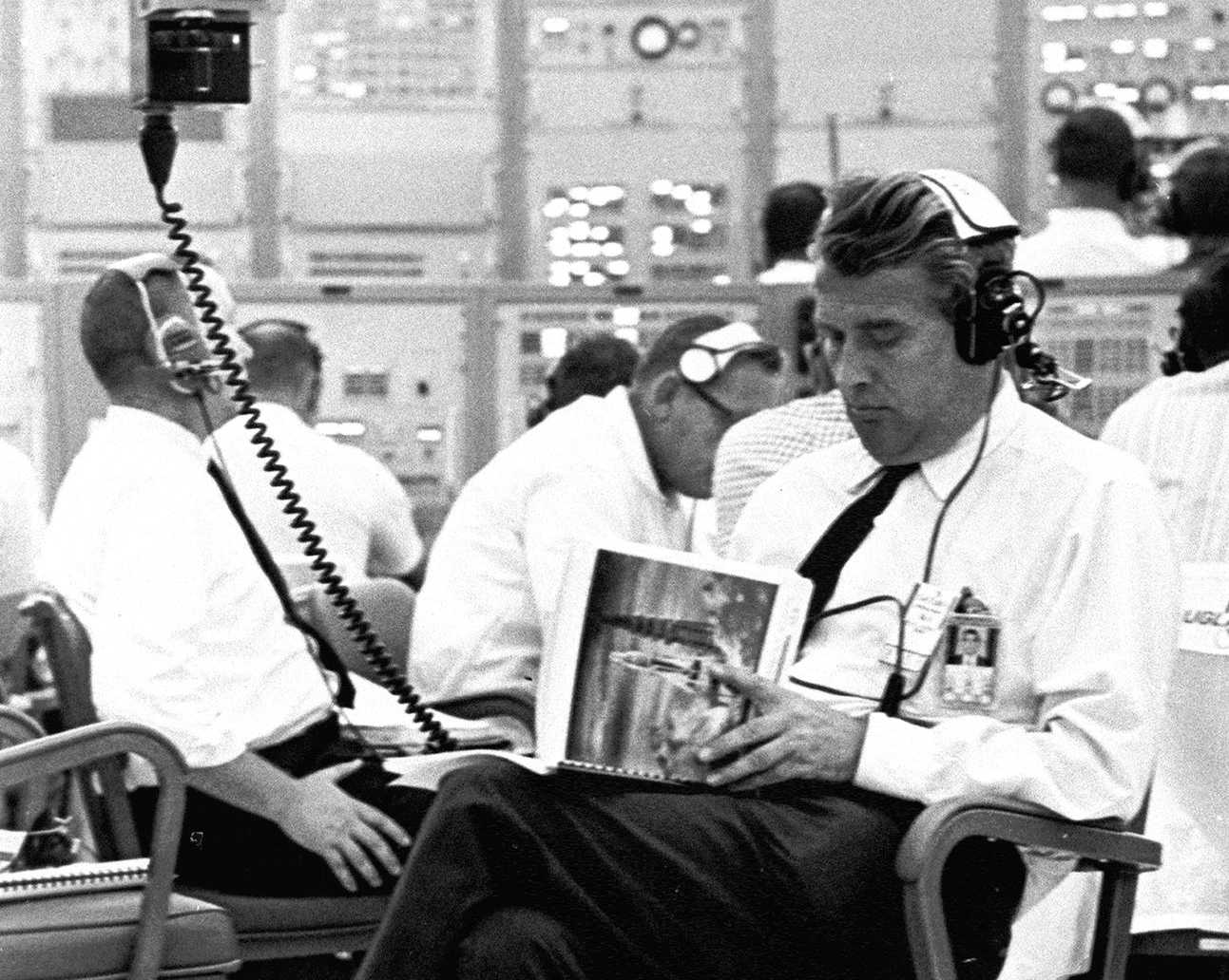 1960s NASA Administrator reads a manual
