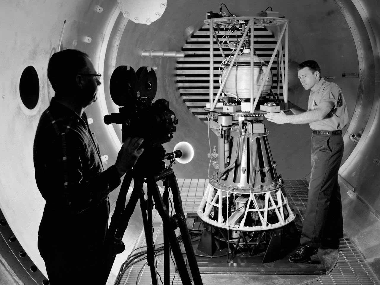 Cameraman films 1960s NASA technician with rocket part