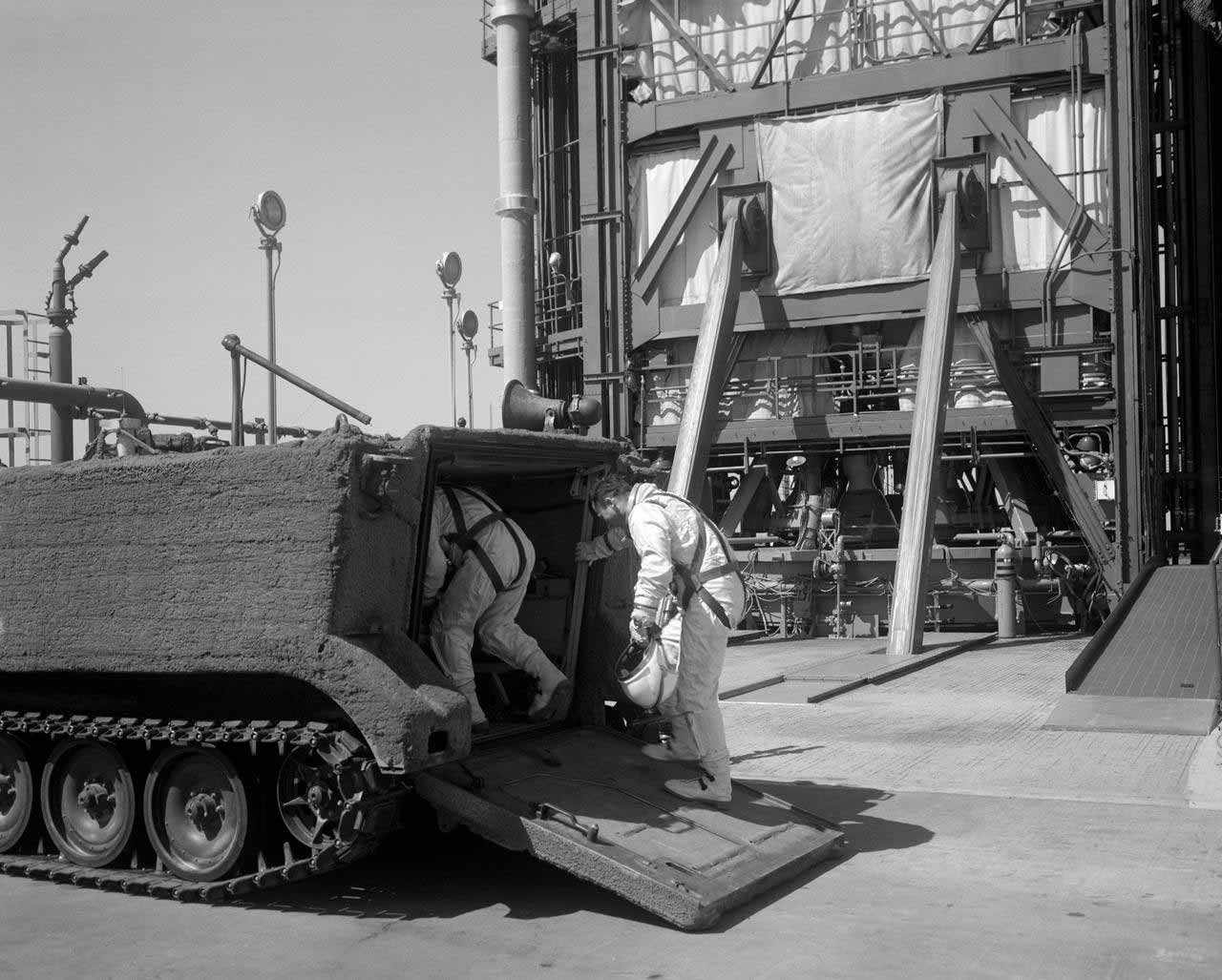 Astronauts entering a crawler near launchpad